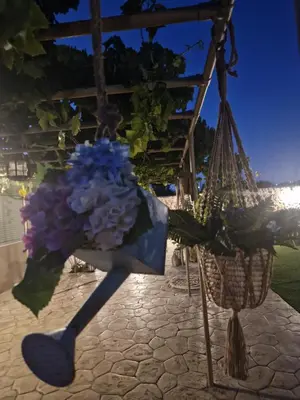 a bouquet of purple flowers in a hanging basket at St'Georges garden house in Palaiá Fókaia