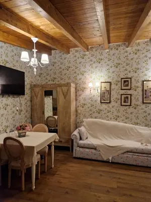 a bedroom with a bed and a table and chairs at St'Georges garden house in Palaiá Fókaia