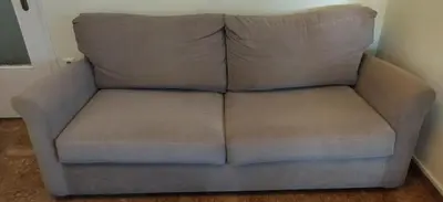 a brown couch sitting in a room at Alimos Kalamaki 100 meters from the Beach in Athens