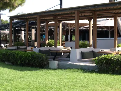 a patio with couches and tables and a pavilion at Alimos Kalamaki 100 meters from the Beach in Athens