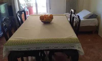 a table with a bowl of fruit on top of it at Alimos Kalamaki 100 meters from the Beach in Athens