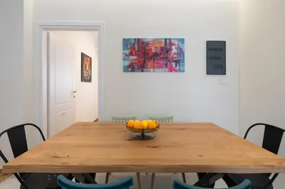 a dining room table with a bowl of fruit on it at LIV - Charming 3BD in Athens Vibrant Downtown in Athens