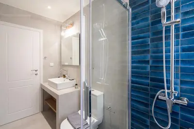 a bathroom with a glass shower and a sink at LIV - Charming 3BD in Athens Vibrant Downtown in Athens
