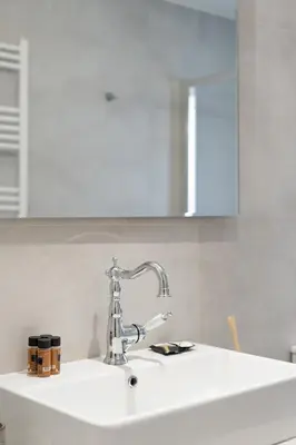 a kitchen sink with a faucet on top of it at LIV - Charming 3BD in Athens Vibrant Downtown in Athens