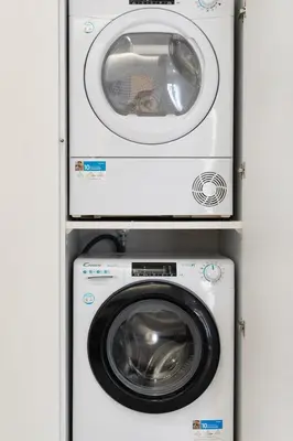 a washing machine and a dryer in a cabinet at LIV - Charming 3BD in Athens Vibrant Downtown in Athens