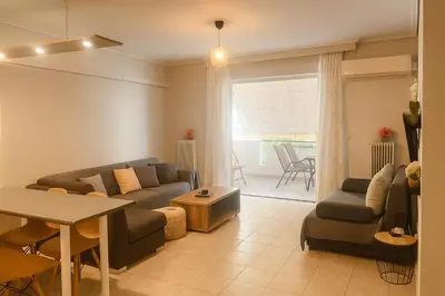a living room with a couch and a table at Neos Kosmos Cozy Retreat - Central Comfort in Athens
