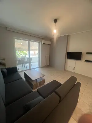 a living room with a couch and a table at Neos Kosmos Cozy Retreat - Central Comfort in Athens