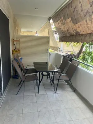 a patio with a table and chairs on a balcony at Neos Kosmos Cozy Retreat - Central Comfort in Athens