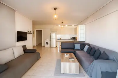 a living room with a couch and a table at Neos Kosmos Cozy Retreat - Central Comfort in Athens