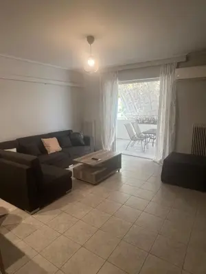a living room with a couch and a table at Neos Kosmos Cozy Retreat - Central Comfort in Athens