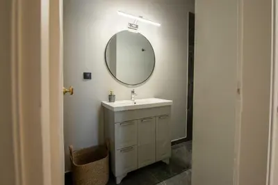 a bathroom with a sink and a mirror at Aerides V Suites in Athens