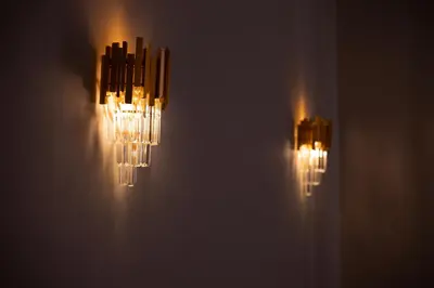 two chandeliers hanging on the wall at Aerides V Suites in Athens