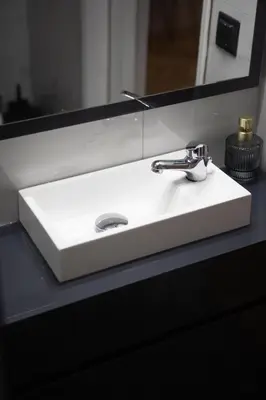 a white bathroom sink in front of a mirror at Aerides V Suites in Athens