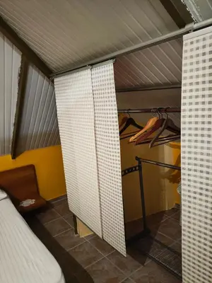 a room with a bed and a closet at Foothills loft in Keratea