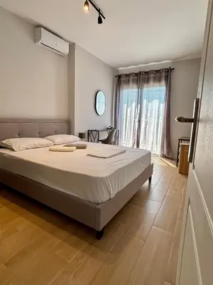 a bedroom with a large bed and a window at Athens penthouse with akropolis view! in Athens