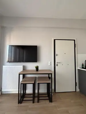 a dining room with a table and bench and a door at Athens penthouse with akropolis view! in Athens