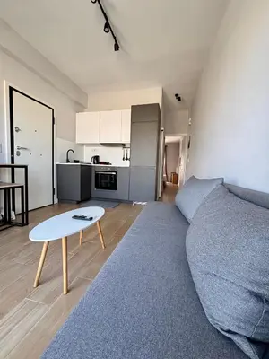 a living room with a couch and a table at Athens penthouse with akropolis view! in Athens