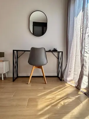 a chair sitting under a desk with a mirror at Athens penthouse with akropolis view! in Athens