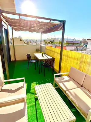 a balcony with a table and chairs and a table and benches at Athens penthouse with akropolis view! in Athens