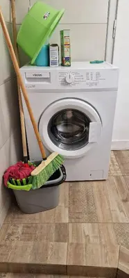 a washing machine with a washer in a room at RolandApartaments in Athens