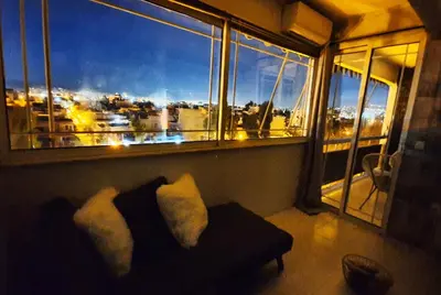 a room with a couch and a window with a view at Panorama house near Teleperformance in Athens