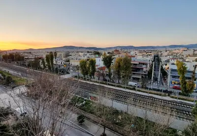 a view of a city with a train tracks at Panorama house near Teleperformance in Athens