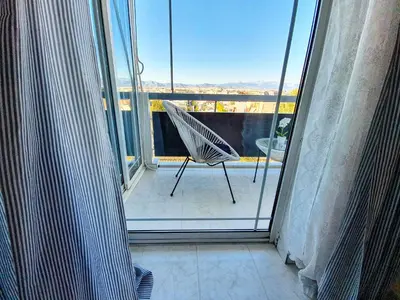 a room with a chair on a balcony at Panorama house near Teleperformance in Athens