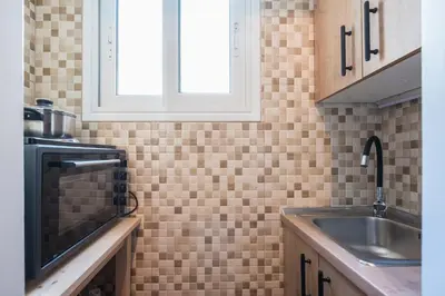 a kitchen with a sink and a window at Cozy Central Gem In Athens 2 min from metro in Athens