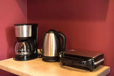 a coffee maker and a blender on a wooden shelf at Cozy Central Gem In Athens 2 min from metro in Athens
