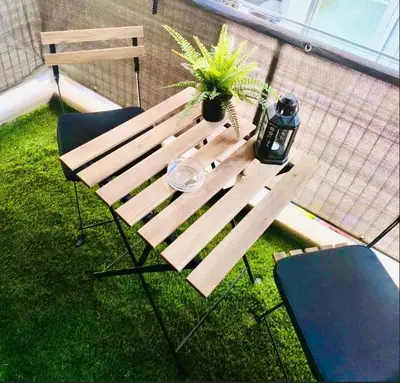 a wooden table with a potted plant on a balcony at Cozy Central Gem In Athens 2 min from metro in Athens