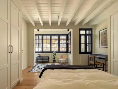 a bedroom with a bed and a desk in it at Bigtrel Athens in Athens
