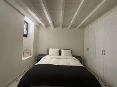 a bedroom with a large bed with white cabinets at Bigtrel Athens in Athens