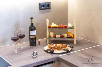 a bottle of wine and a plate of food and wine glasses at Seaside Luxury - 3 Min to Freatida Beach in Piraeus