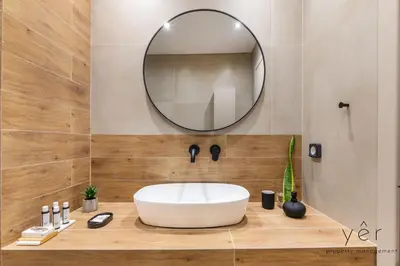 a bathroom with a white sink and a mirror at Seaside Luxury - 3 Min to Freatida Beach in Piraeus