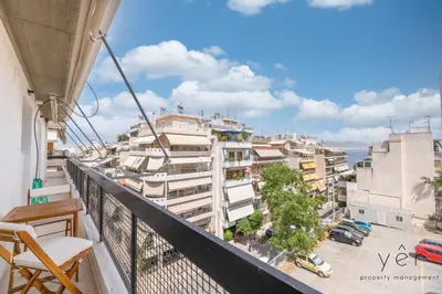 a balcony with a view of a city at Seaside Luxury - 3 Min to Freatida Beach in Piraeus