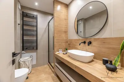 a bathroom with a sink and a mirror at Seaside Luxury - 3 Min to Freatida Beach in Piraeus