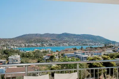 a view from a balcony of a city and a river at Kalesma Hilltop Apartment by A&D Properties in Porto Rafti
