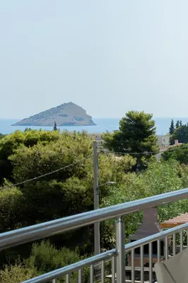 a view of an island from a balcony at Kalesma Hilltop Apartment by A&D Properties in Porto Rafti