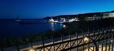 a view of a body of water at night at Anatoli Hotel in Agia Marina Aegina