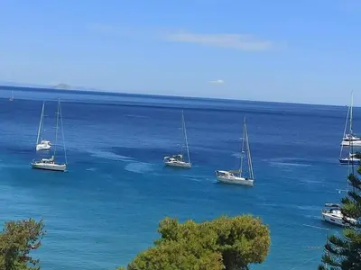 a group of boats floating in the water at Anatoli Hotel in Agia Marina Aegina