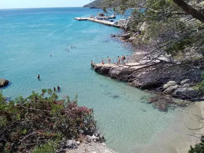 a group of people in the water at a beach at Anatoli Hotel in Agia Marina Aegina