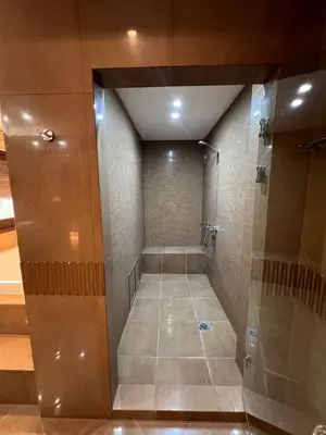 a walk in shower with a glass door at Sunset Villa in Saronida