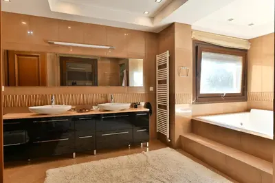 a bathroom with two sinks and a bath tub at Sunset Villa in Saronida