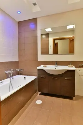 a bathroom with a tub and a sink and a mirror at Sunset Villa in Saronida