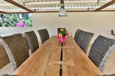 a wooden table with a vase of flowers on it at Sunset Villa in Saronida