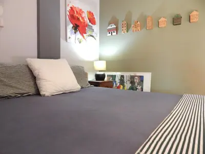 a bedroom with a bed and a picture on the wall at Casa di Tsakos Luxury apartment in Athens