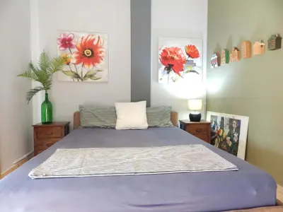 a bedroom with a bed with purple sheets and flowers at Casa di Tsakos Luxury apartment in Athens