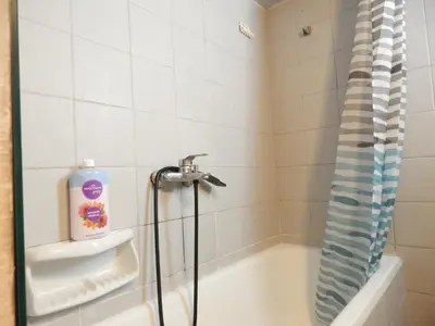 a bathroom with a shower and a bath tub at Casa di Tsakos Luxury apartment in Athens
