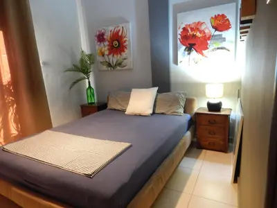 a bedroom with a bed and a painting on the wall at Casa di Tsakos Luxury apartment in Athens