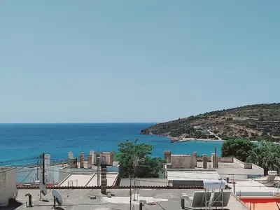 a view of the ocean from a building at Hotel Liliana in Agia Marina Aegina